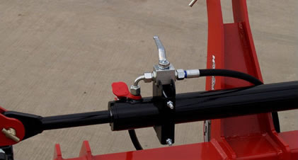 close up photo of the comb harrow's hydraulic cylinder