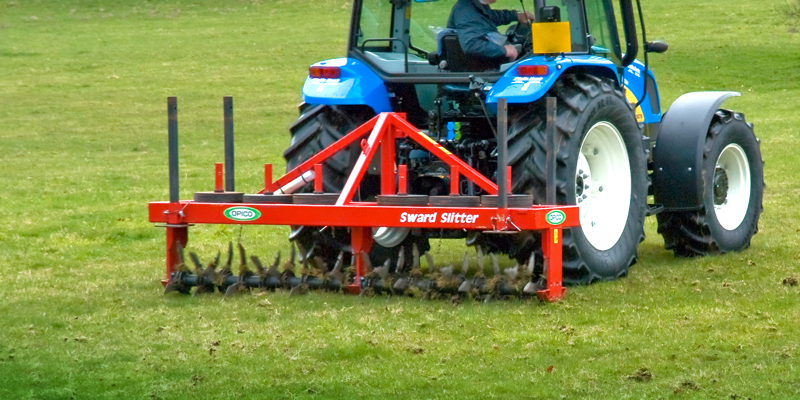 OPICO Sward Slitter behind a New Holland tractor